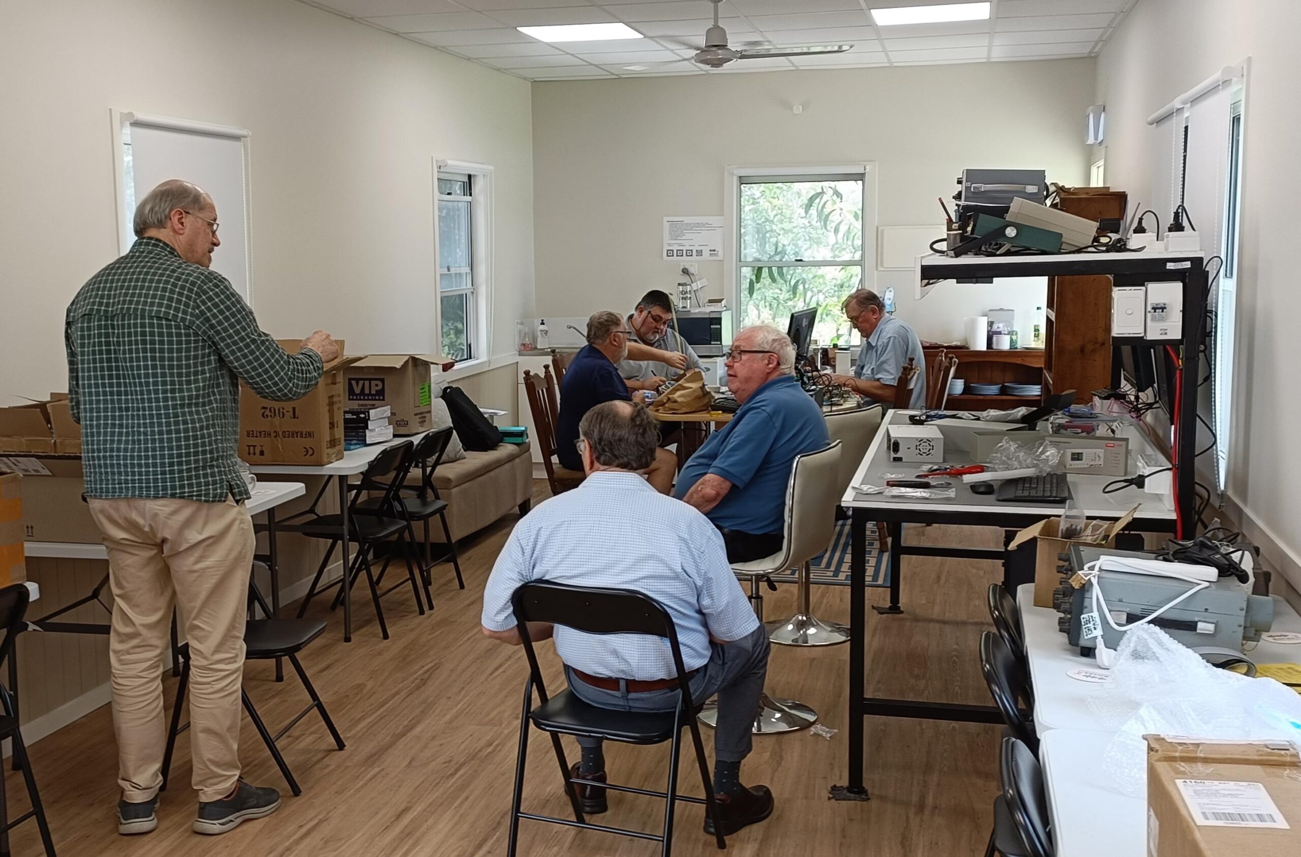 busy members doing electronics at the clubhouse